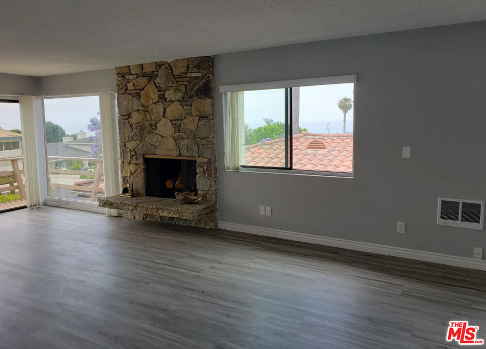 7 Clipper Road Rancho Palos Verdes, CA 90275 - Photo 9 of 20 wooden floor fireplace and windows in an empty room