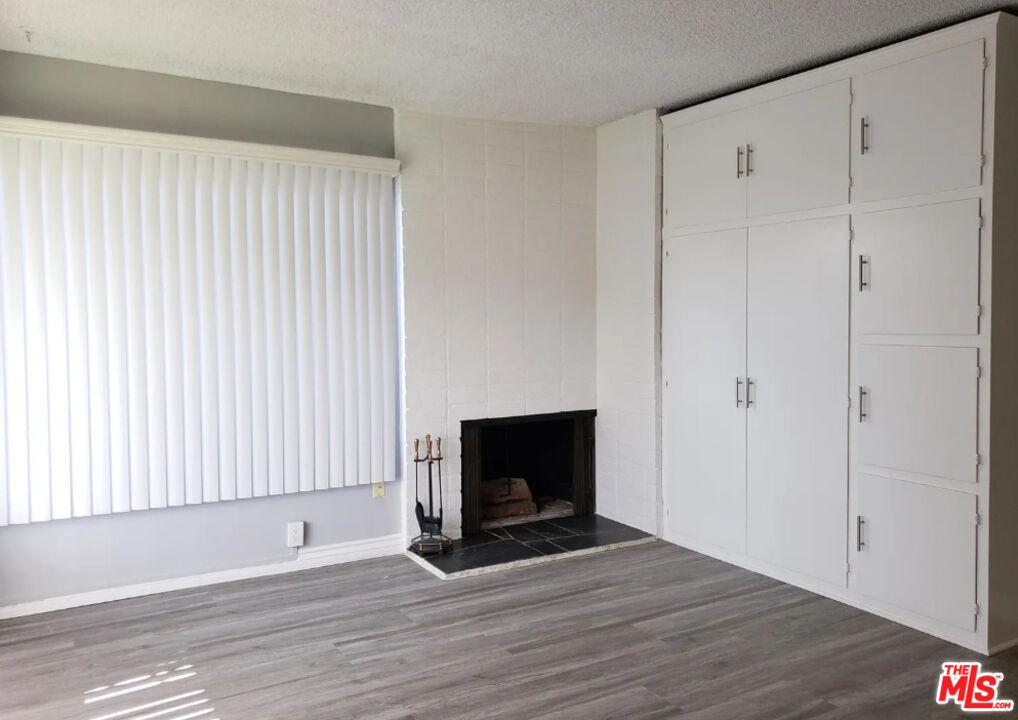 7 Clipper Road Rancho Palos Verdes, CA 90275 - Photo 10 of 20 a view of an empty room with wooden floor and a fireplace