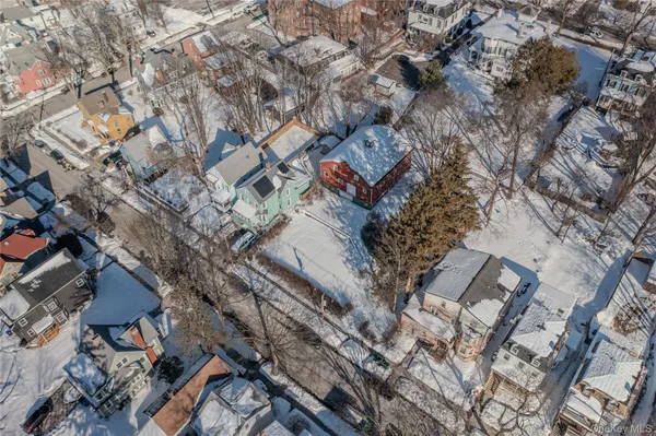 an aerial view of a house with a yard