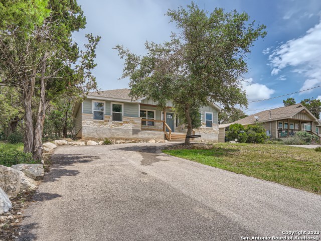 1141 Highpoint Lane Spring Branch, TX 78070 - Photo 1 of 1 a front view of a house with a yard and trees