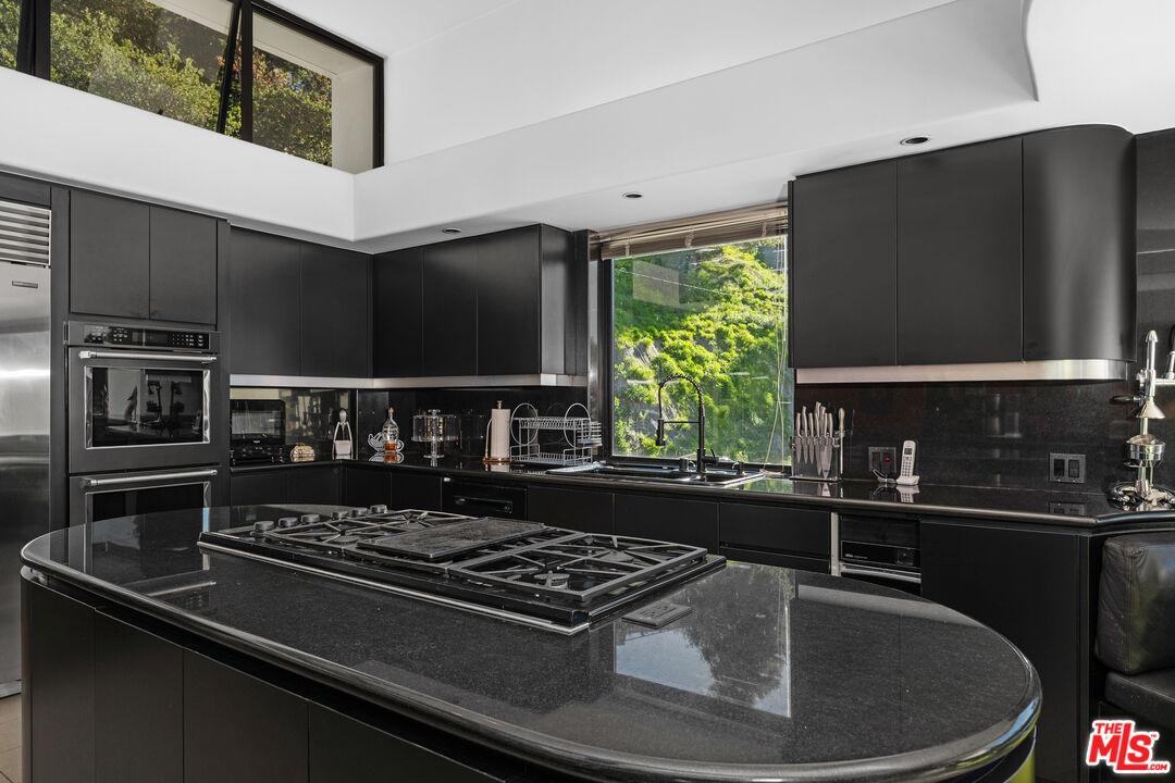 477 Upper Mesa Road Santa Monica, CA 90402 - Photo 12 of 30 a kitchen with a stove and a microwave