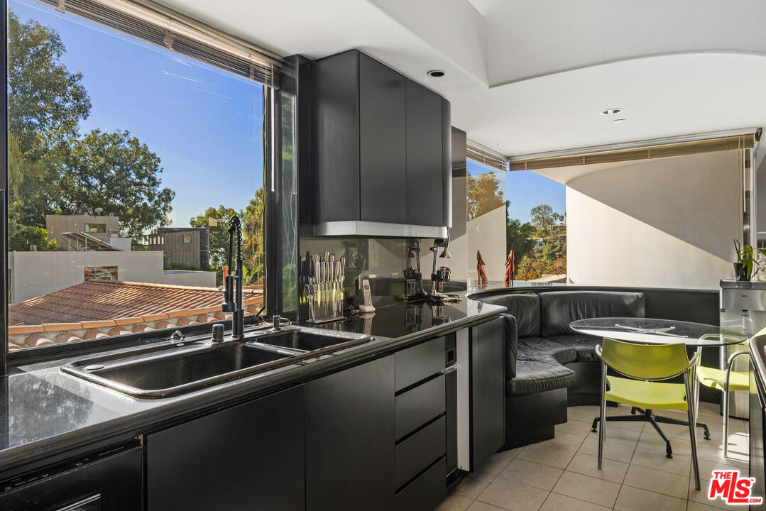 477 Upper Mesa Road Santa Monica, CA 90402 - Photo 13 of 30 a kitchen with a sink and cabinets