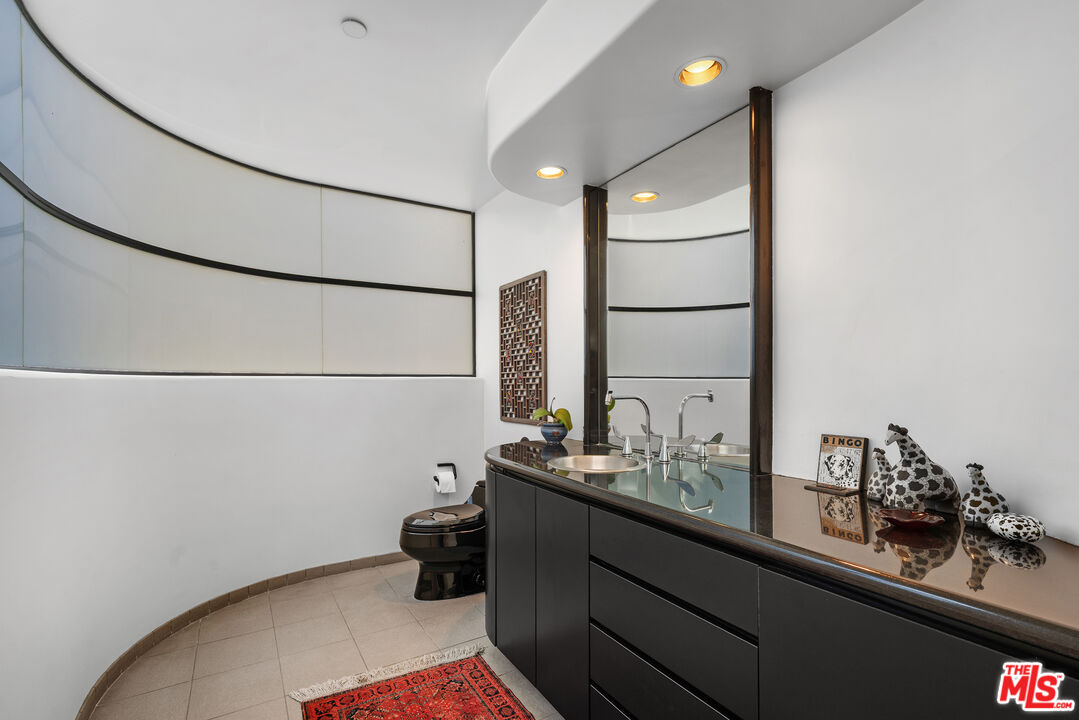 477 Upper Mesa Road Santa Monica, CA 90402 - Photo 14 of 30 a bathroom with a sink and a mirror