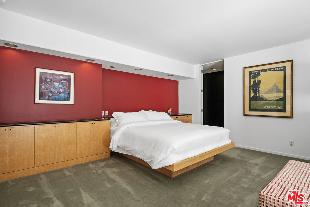 477 Upper Mesa Road Santa Monica, CA 90402 - Photo 18 of 30 a bedroom with a bed and painting on the wall