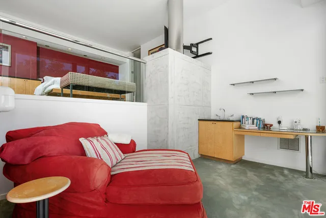 a bedroom with a bed and a desk