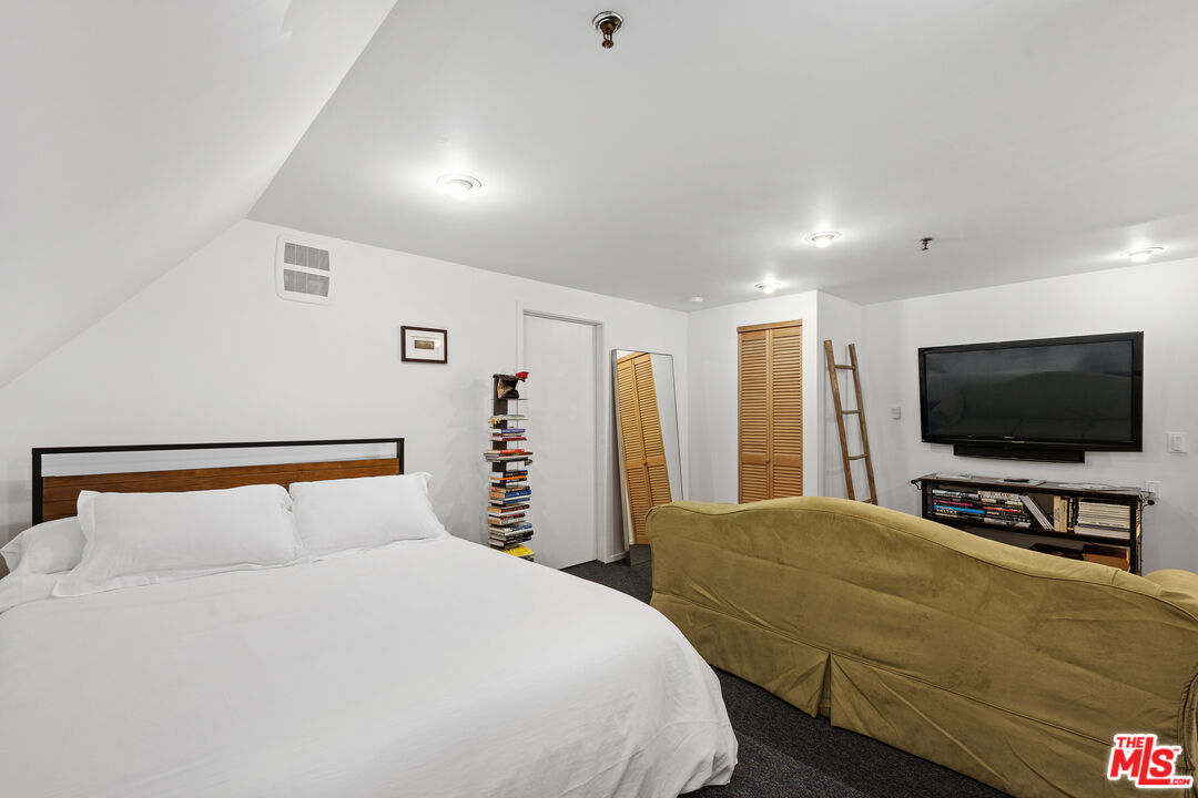 477 Upper Mesa Road Santa Monica, CA 90402 - Photo 23 of 30 a bedroom with a bed and a flat screen tv