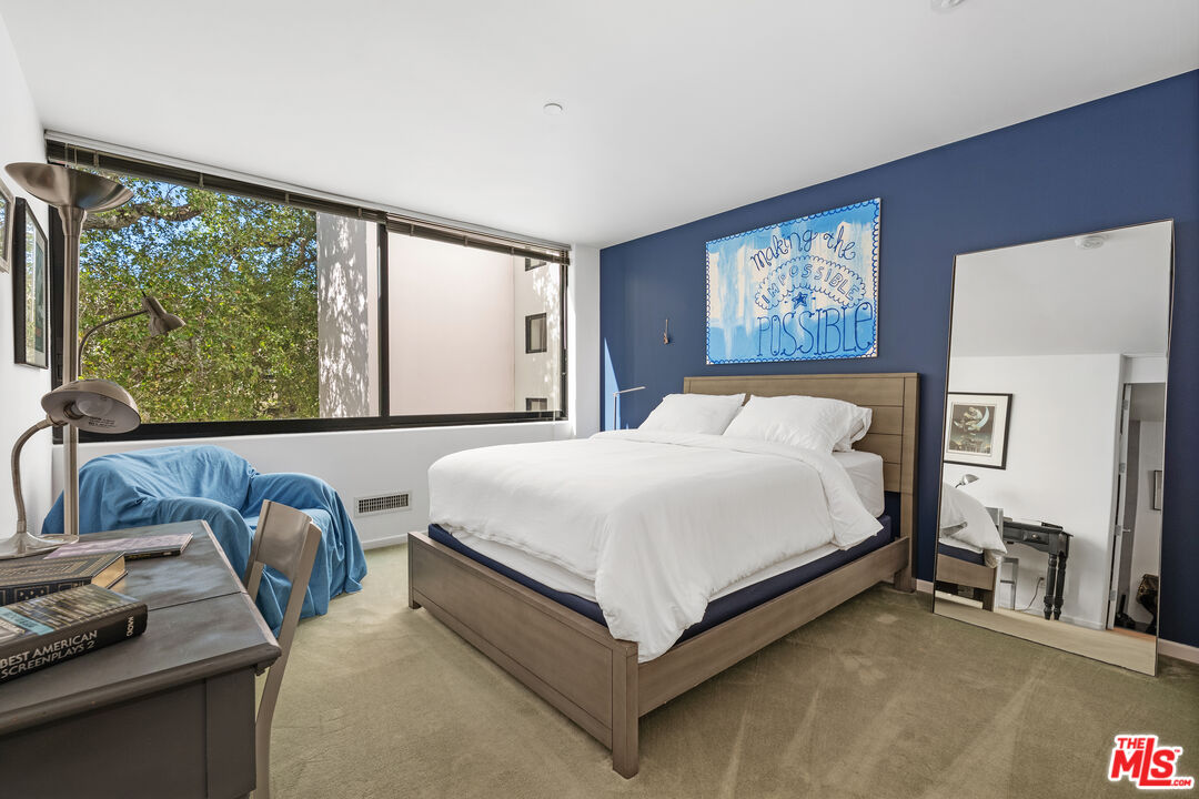 477 Upper Mesa Road Santa Monica, CA 90402 - Photo 24 of 30 a bedroom with a bed and glass window