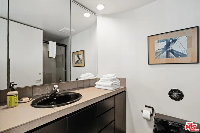 a bathroom with a sink double vanity and a mirror