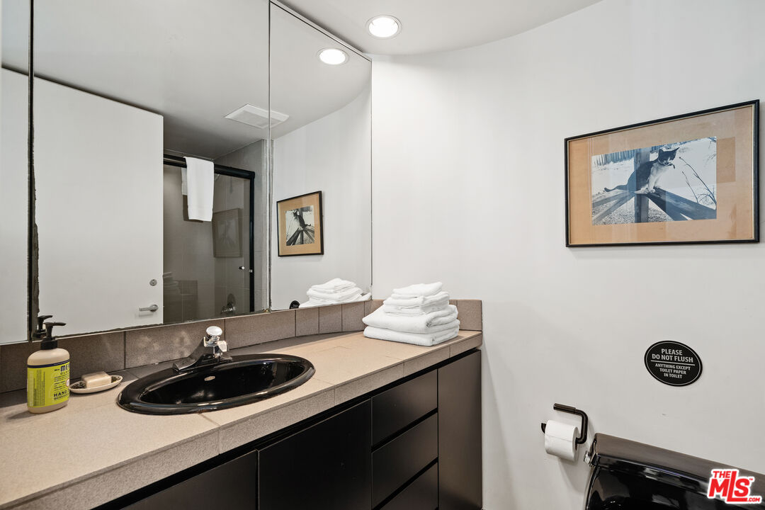 477 Upper Mesa Road Santa Monica, CA 90402 - Photo 26 of 30 a bathroom with a sink double vanity and a mirror