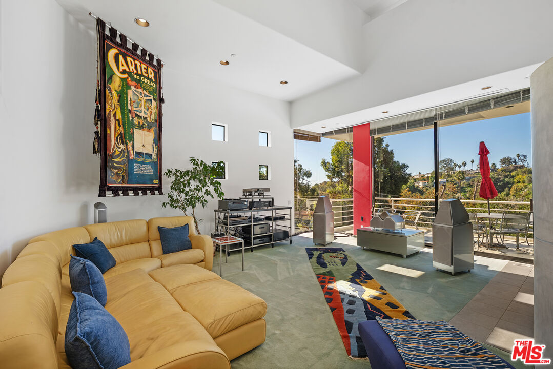 477 Upper Mesa Road Santa Monica, CA 90402 - Photo 4 of 30 a living room filled with furniture and a table