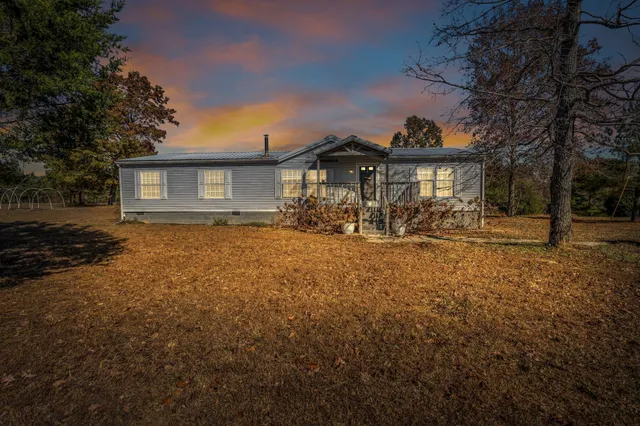 an aerial view of residential house with parking space and mountain view in back