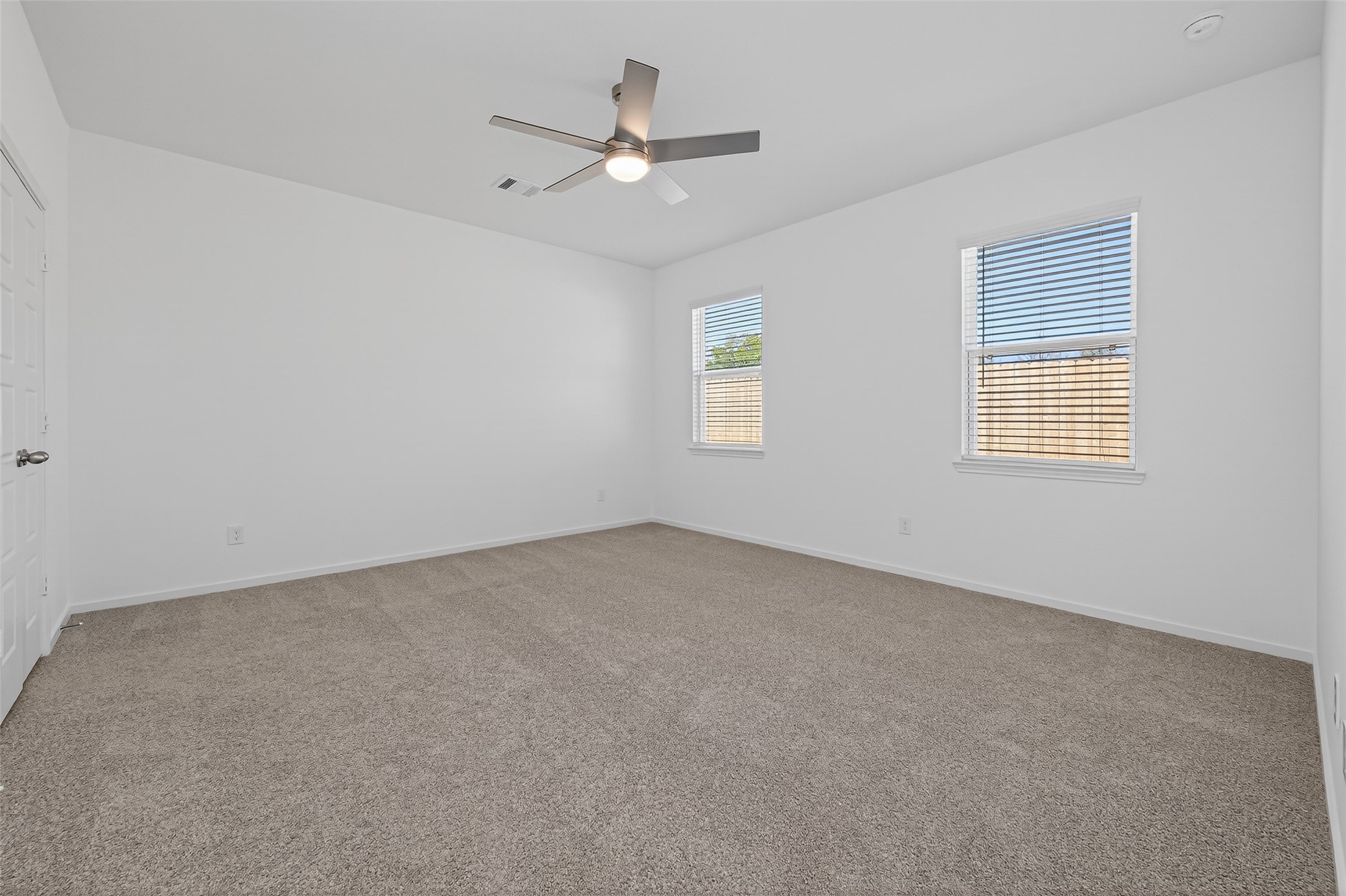 9734 Enclave Ridge Road Willis, TX 77318 - Photo 16 of 29 an empty room with a window and a ceiling fan