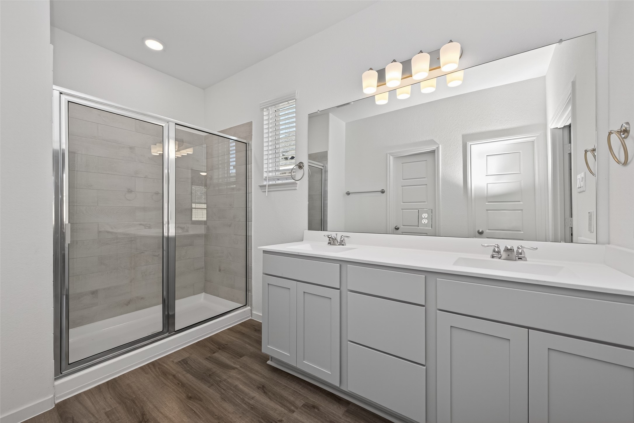 9734 Enclave Ridge Road Willis, TX 77318 - Photo 19 of 29 a bathroom with a shower sink and mirror