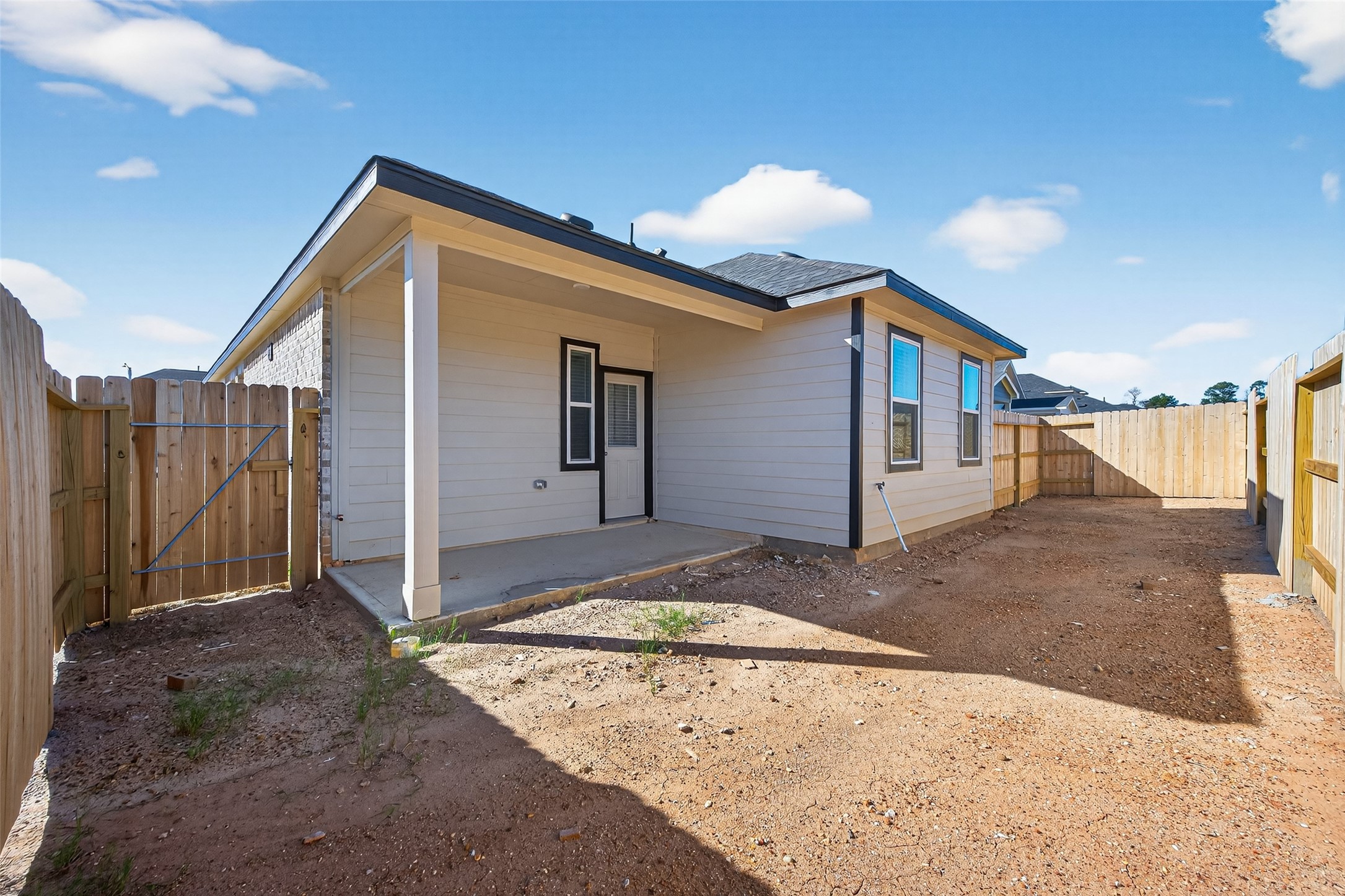 9734 Enclave Ridge Road Willis, TX 77318 - Photo 27 of 29 a view of a house with a backyard