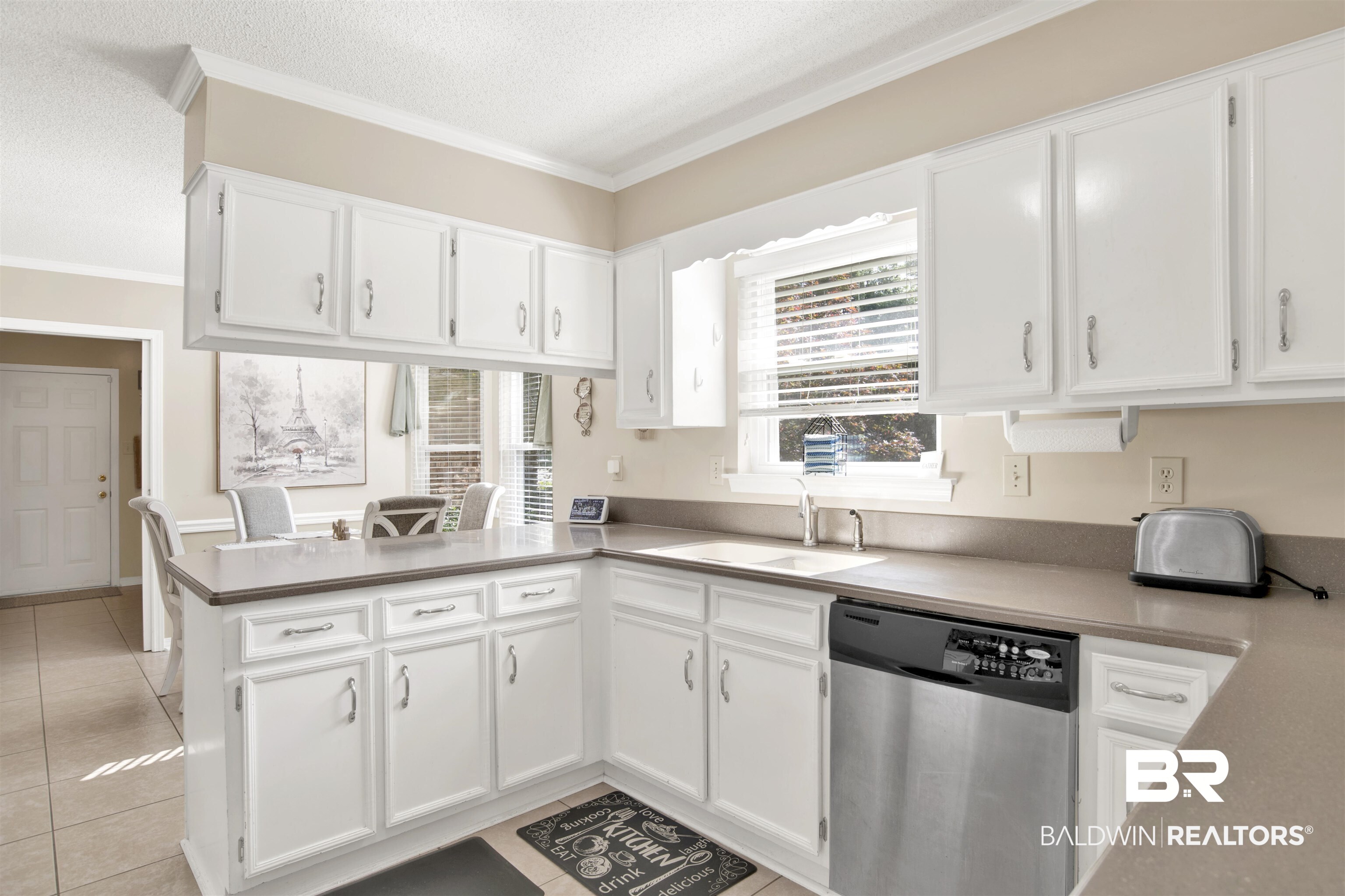 7431 Summer Court Mobile, AL 36695 - Photo 12 of 37 Kitchen with dishwasher, a sink, white cabinets, a peninsula, and ornamental molding