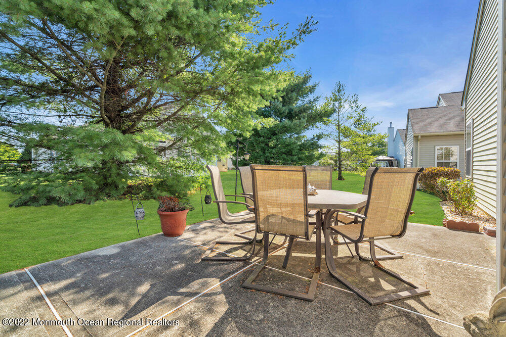 2 Ravenna Road Manchester Township, NJ 08759 - Photo 40 of 40 a view of a chairs and table in backyard of the house