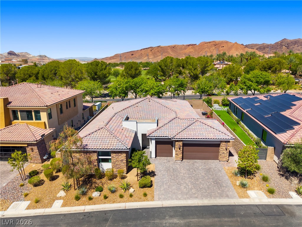 45 Garibaldi Way Henderson, NV 89011 - Photo 44 of 74 Desert-inspired landscaping embraces this home, complemented by durable tile roofing and a spacious paver driveway.
