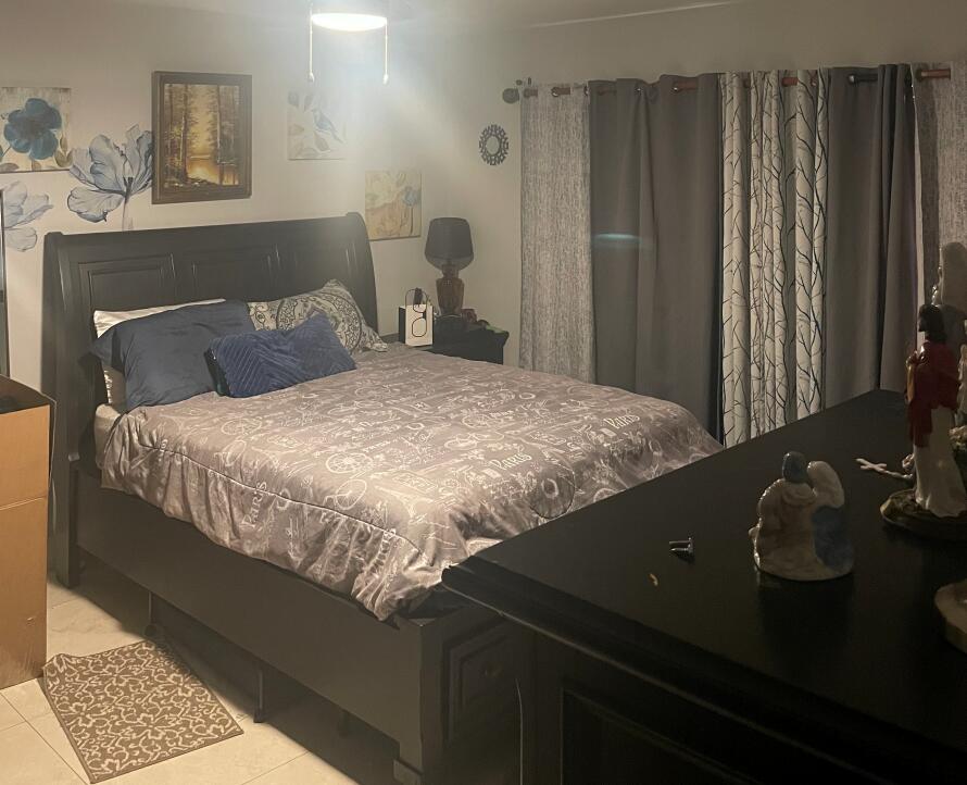 4403 Rende Lane Lake Worth, FL 33461 - Photo 13 of 14 a bedroom with a bed and a window