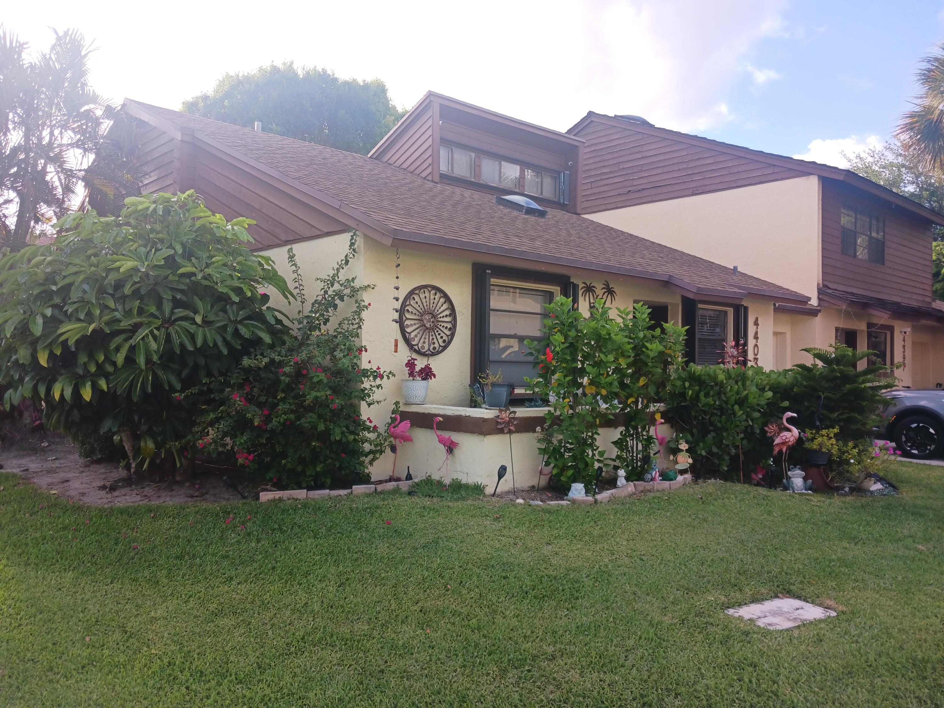 4403 Rende Lane Lake Worth, FL 33461 - Photo 2 of 14 a front view of a house with garden
