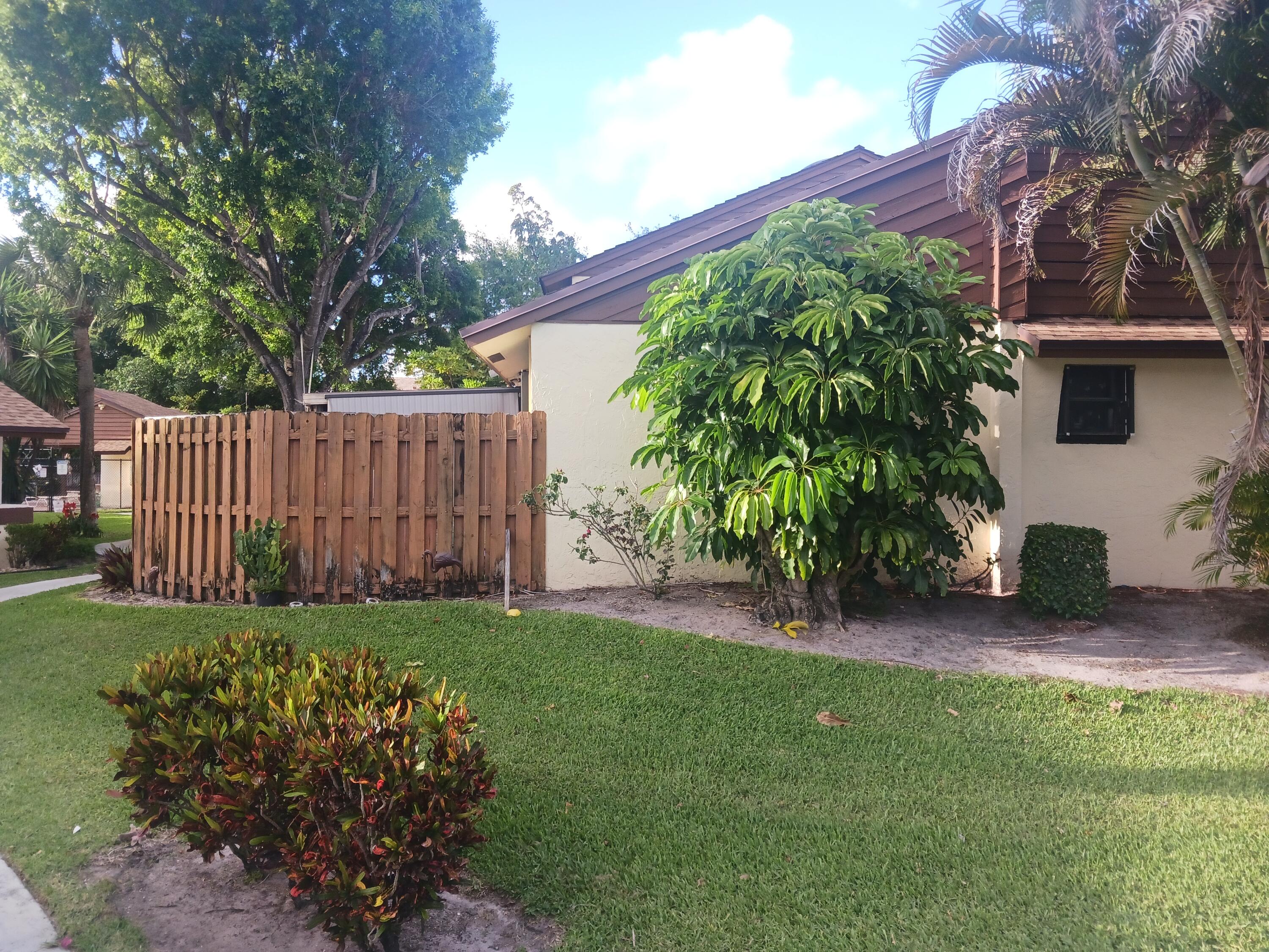 4403 Rende Lane Lake Worth, FL 33461 - Photo 5 of 14 a garden with trees in front of it