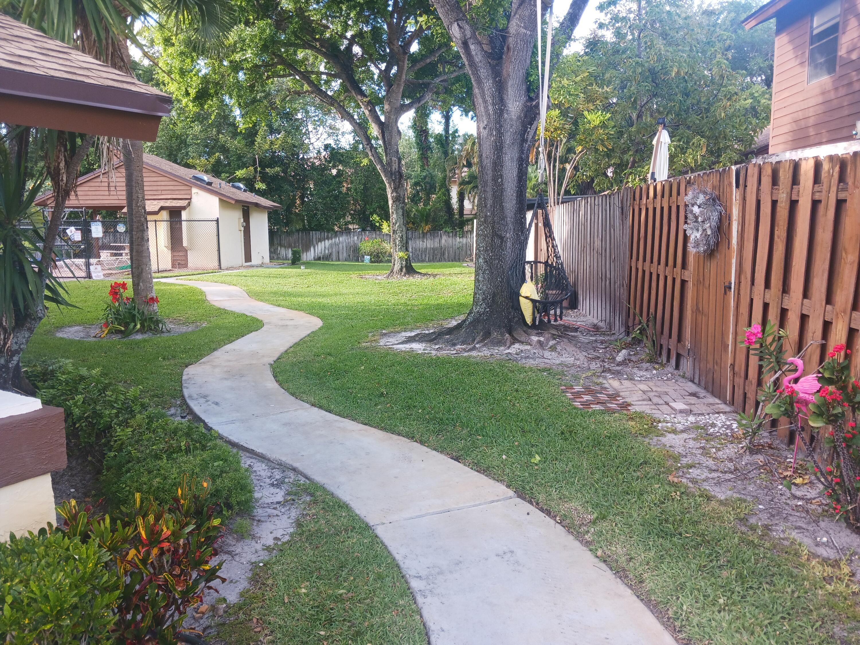 4403 Rende Lane Lake Worth, FL 33461 - Photo 9 of 14 a view of a house with backyard and a tree