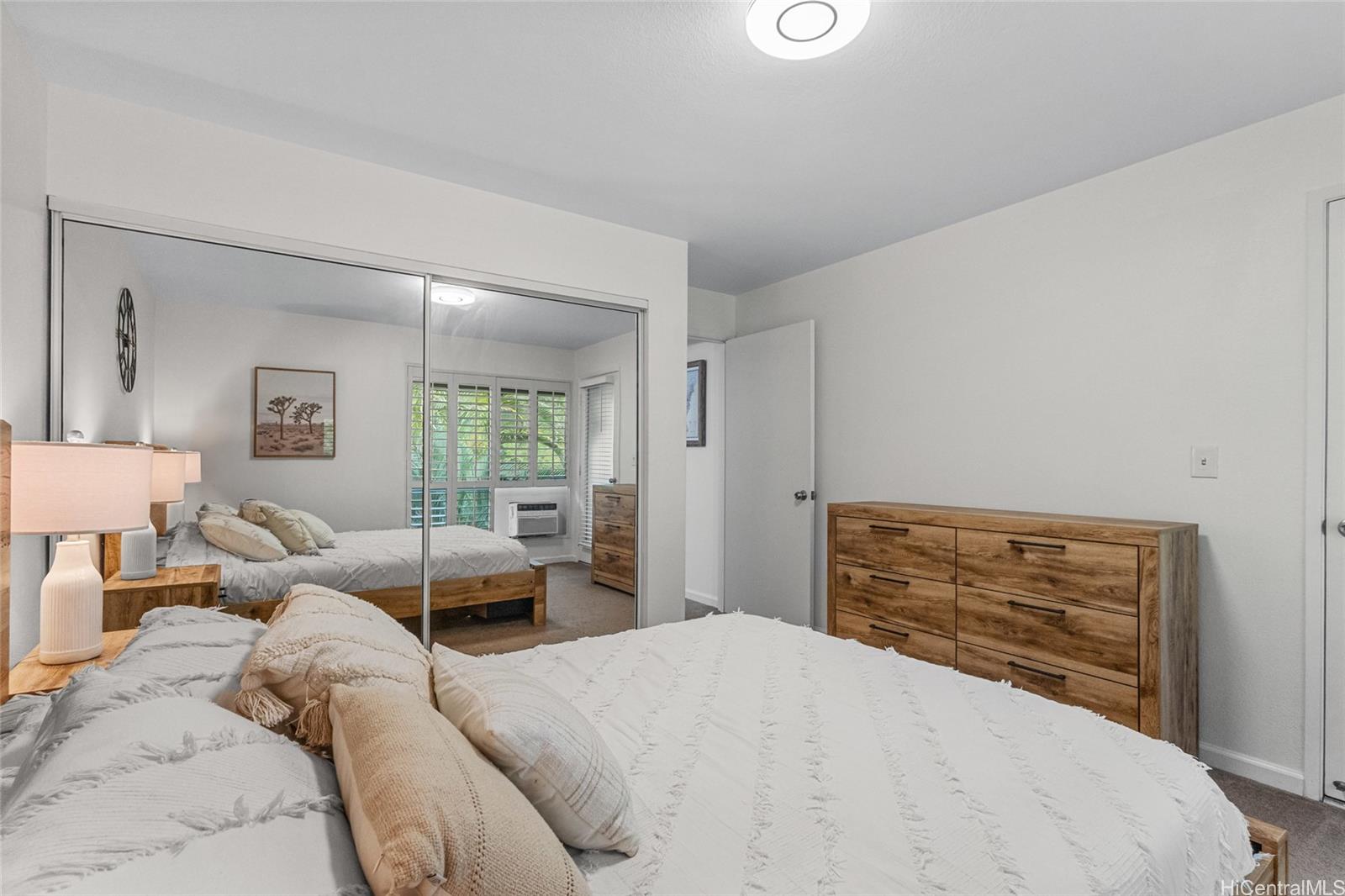 95-660 Wikao Street, Unit K304 Mililani, HI 96789 - Photo 13 of 24 a bedroom with a bed and wooden floor