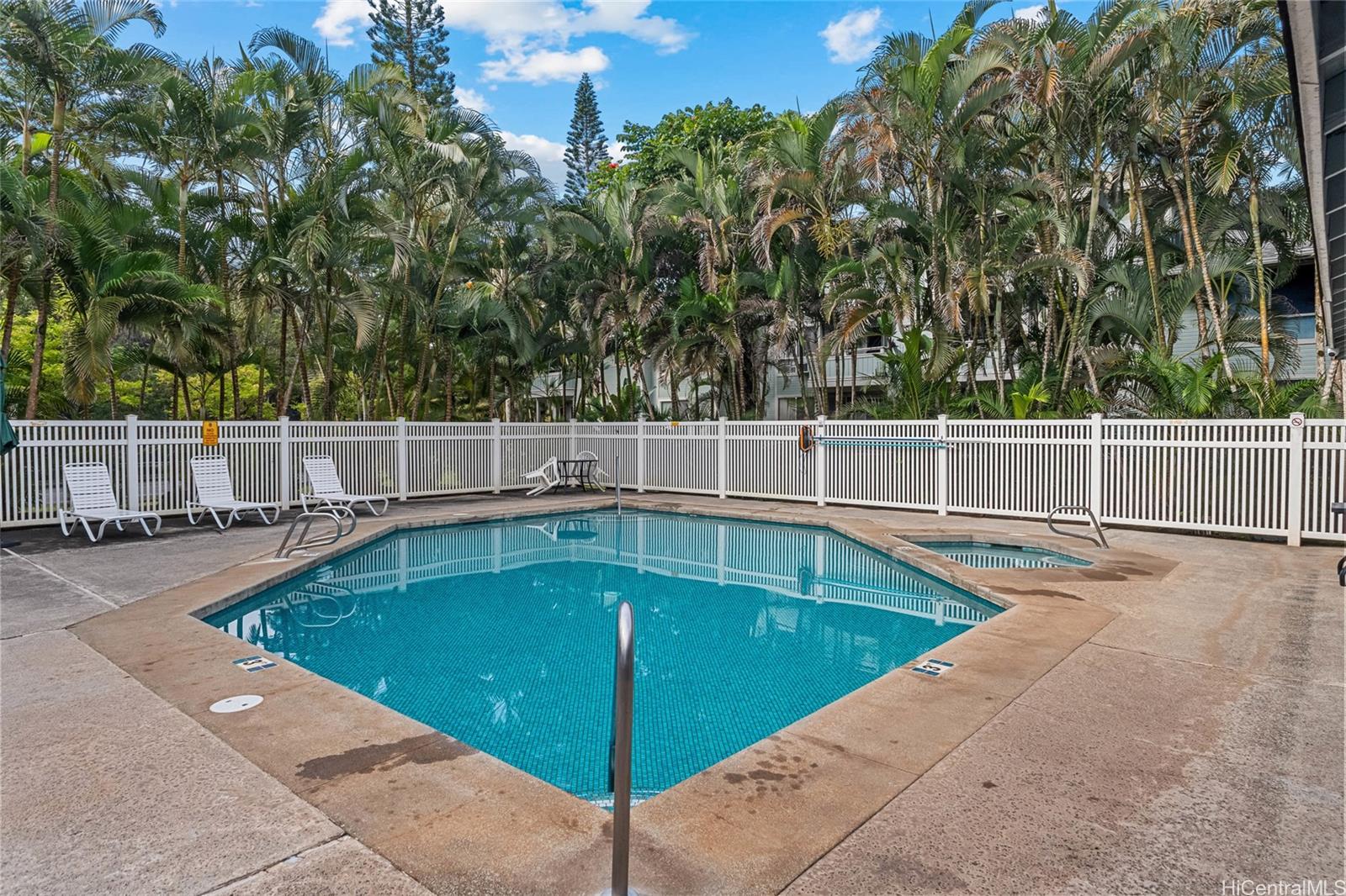 95-660 Wikao Street, Unit K304 Mililani, HI 96789 - Photo 20 of 24 a view of a swimming pool with a yard