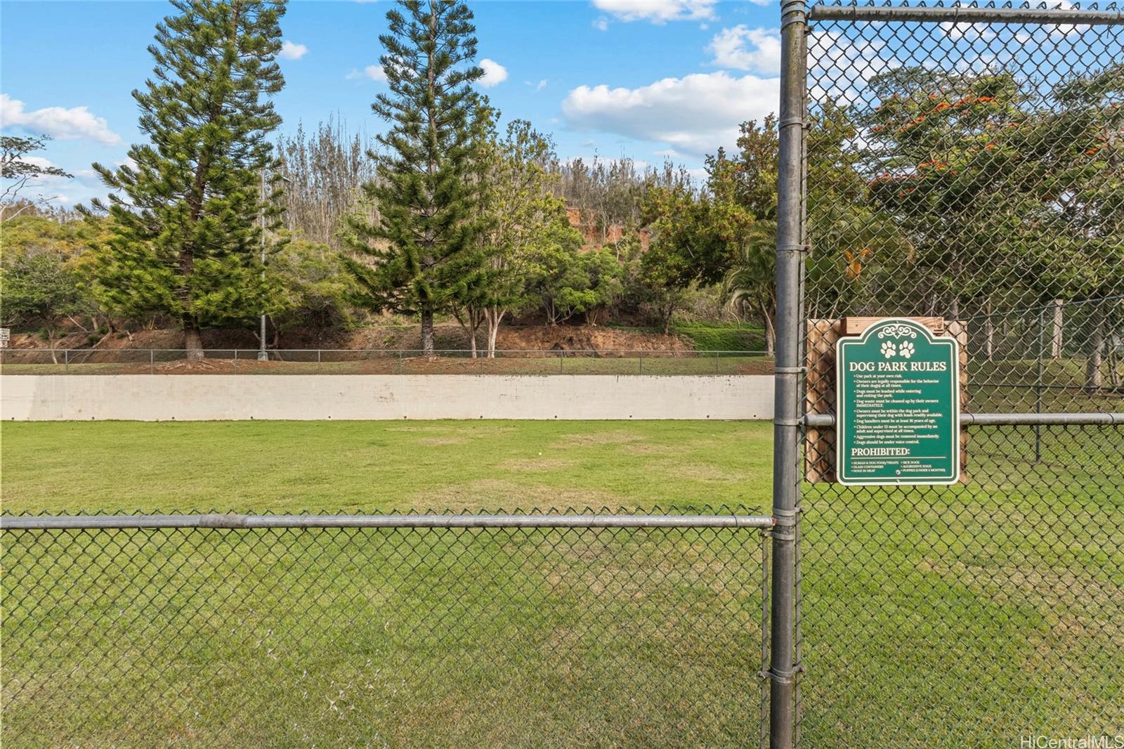 95-660 Wikao Street, Unit K304 Mililani, HI 96789 - Photo 22 of 24 a view of yard with swimming pool and trees