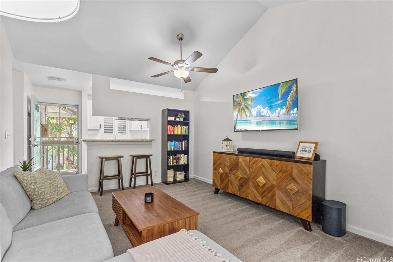 95-660 Wikao Street, Unit K304 Mililani, HI 96789 - Photo 3 of 24 a living room with furniture and a flat screen tv