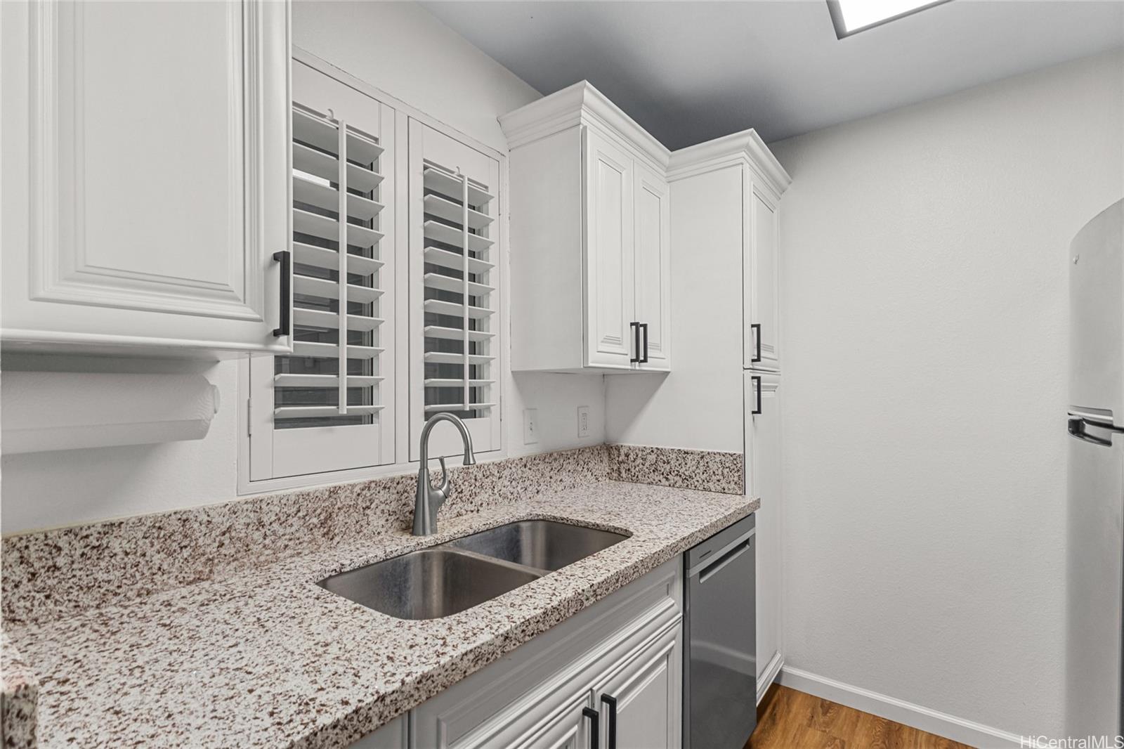 95-660 Wikao Street, Unit K304 Mililani, HI 96789 - Photo 6 of 24 a kitchen with a sink and cabinets