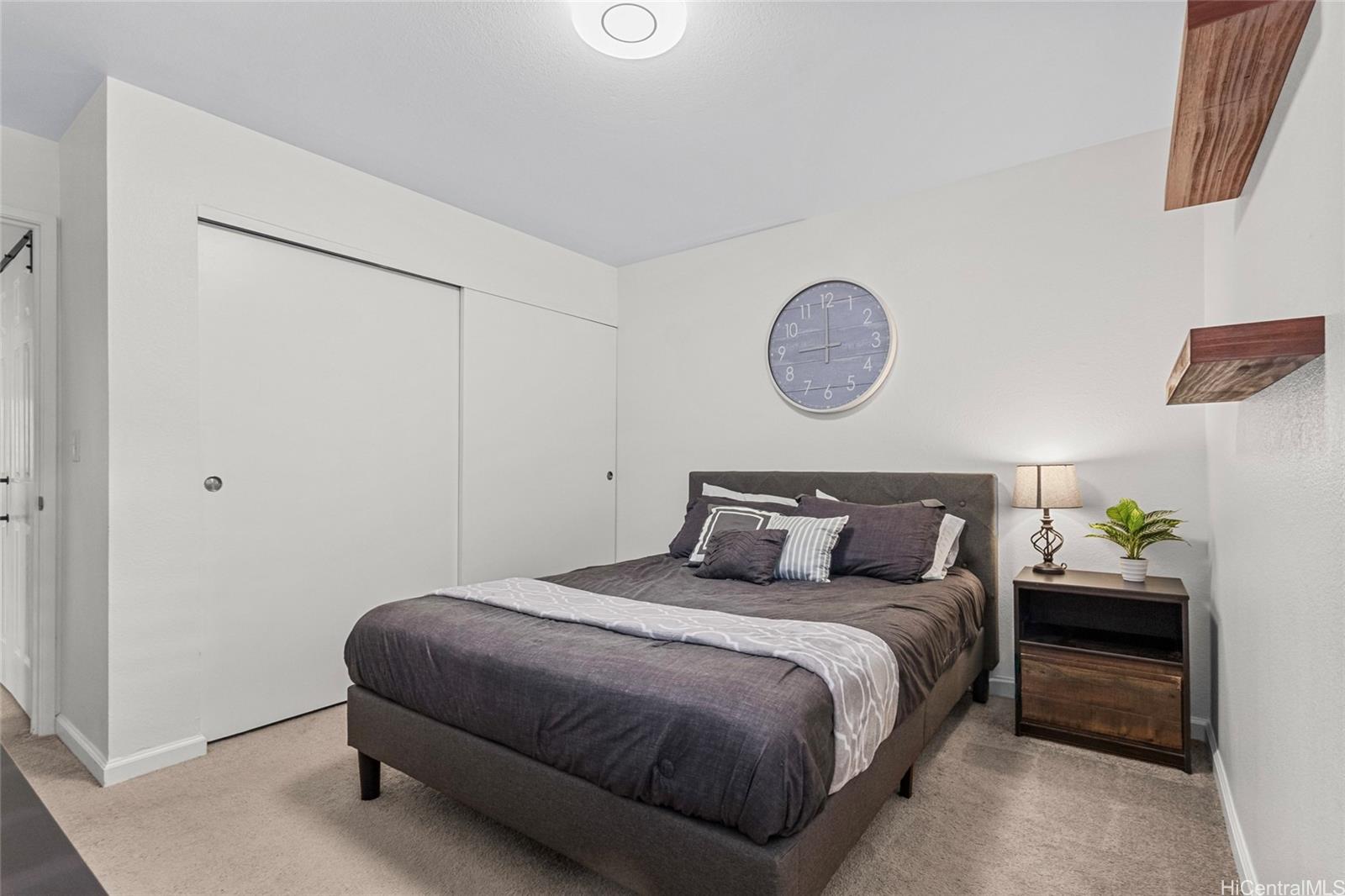 95-660 Wikao Street, Unit K304 Mililani, HI 96789 - Photo 8 of 24 a bedroom with a bed and a window