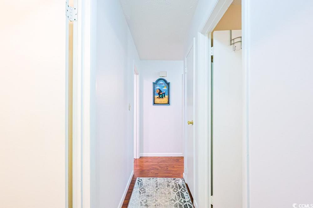 801 Talbot Circle Myrtle Beach, SC 29577 - Photo 22 of 40 Hallway with baseboards and wood finished floors