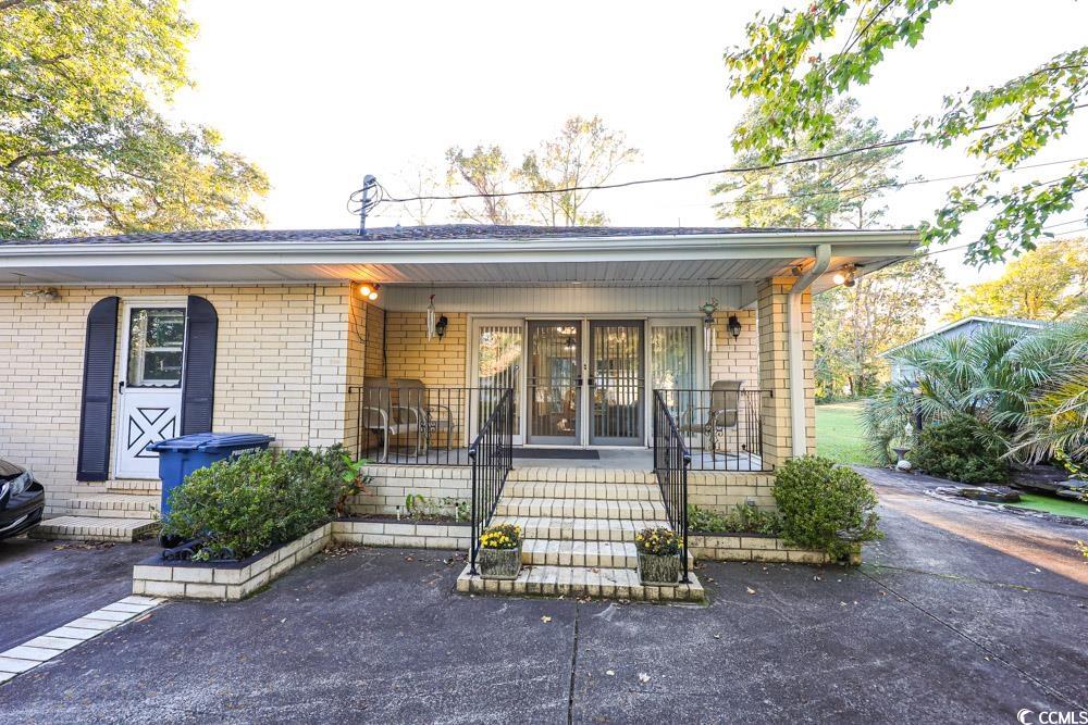 801 Talbot Circle Myrtle Beach, SC 29577 - Photo 34 of 40 View of front facade with covered porch and brick siding
