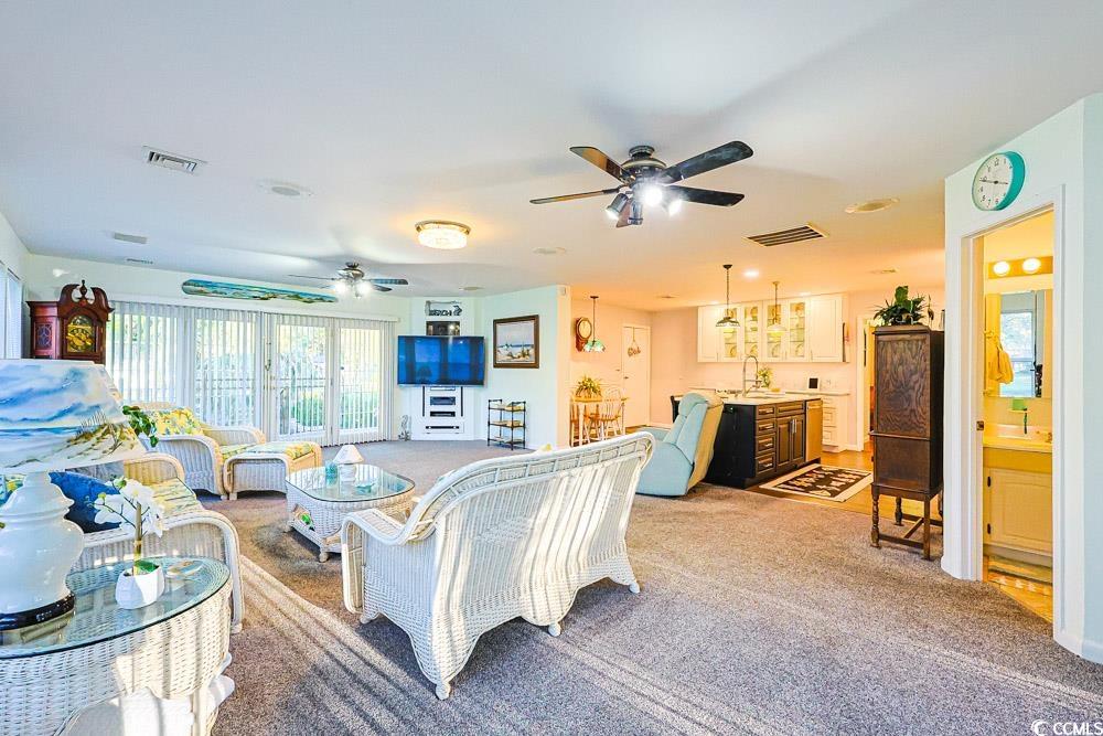 801 Talbot Circle Myrtle Beach, SC 29577 - Photo 4 of 40 Carpeted living area with a ceiling fan and a sink