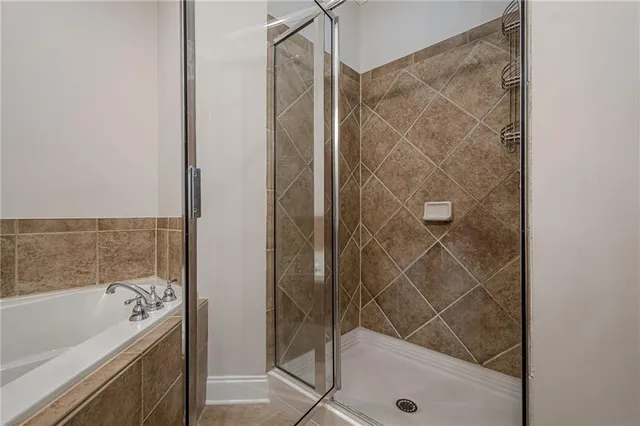 a bathroom with a tub and shower