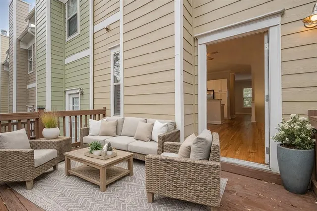 a view of a patio with couches and a potted plant on a table