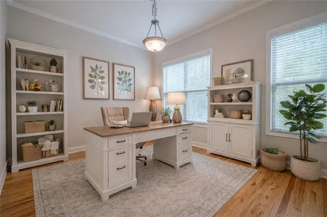a view of a workspace with furniture and a window