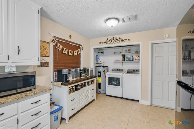 a kitchen with stainless steel appliances a stove and cabinets