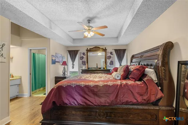 a bedroom with a bed and a mirror