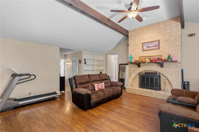 a living room with furniture and a fireplace
