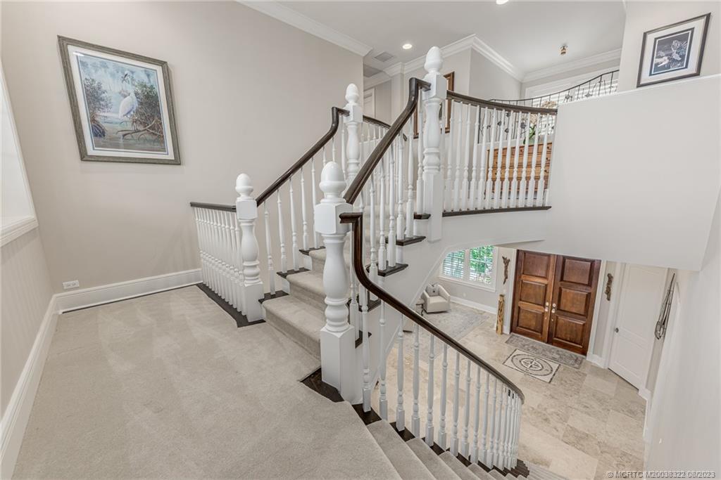 1455 Southeast Riverside Drive Stuart, FL 34996 - Photo 80 of 100 Grand stairway with beautiful balustrade, all new plush carpeting on stairs with extra thick padding