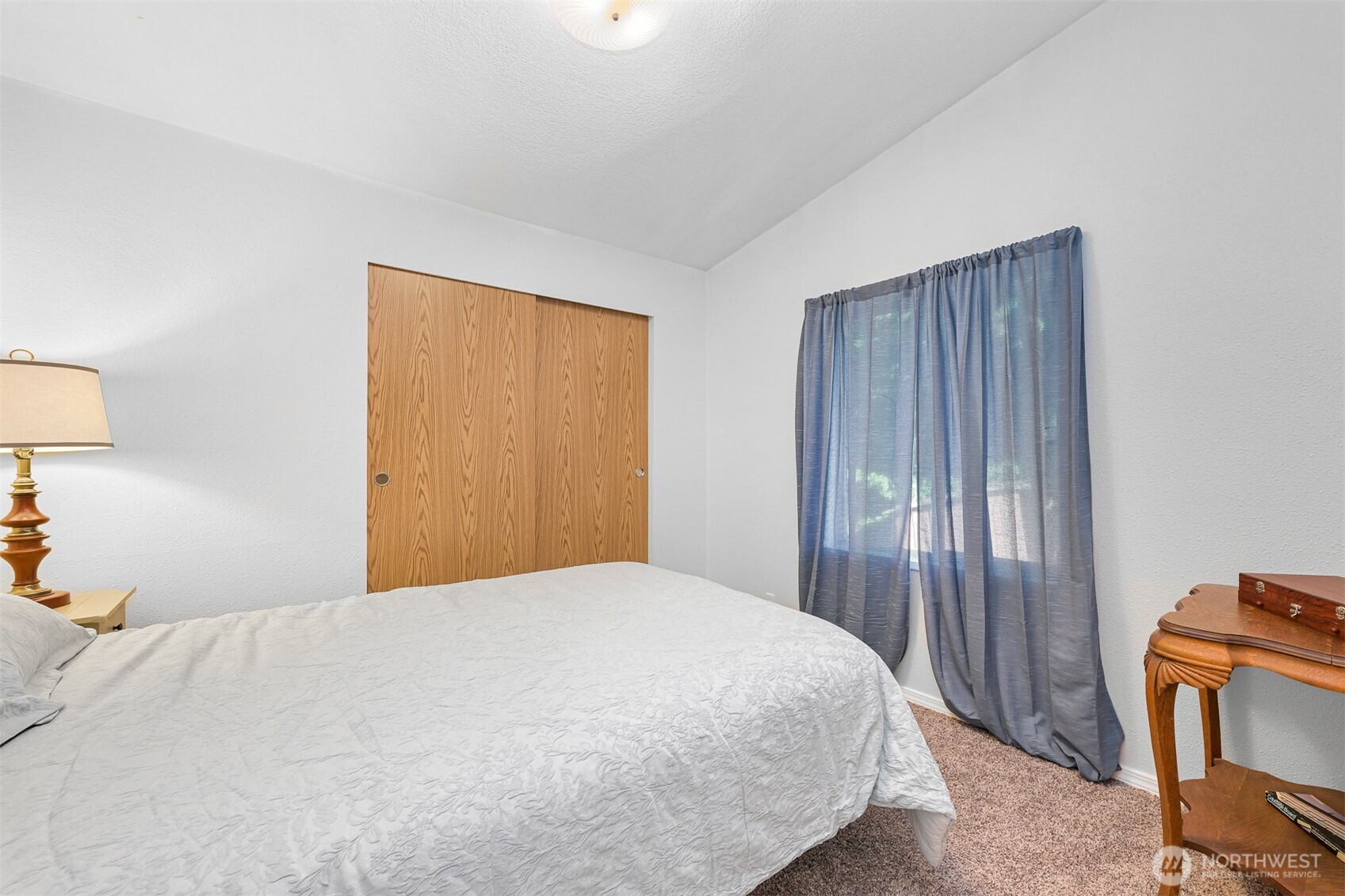 2174 Yew Street Road, Unit 22 Bellingham, WA 98229 - Photo 12 of 36 a bedroom with a bed and wooden floor