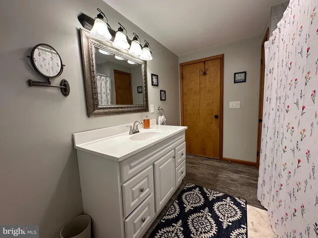 a bathroom with a sink a toilet and a mirror