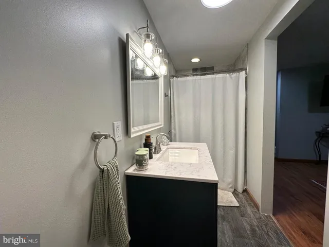 a bathroom with a sink vanity and a mirror