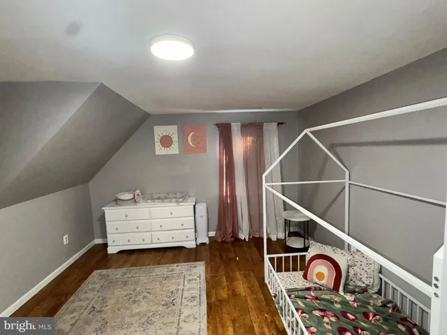 a view of room with wooden floor