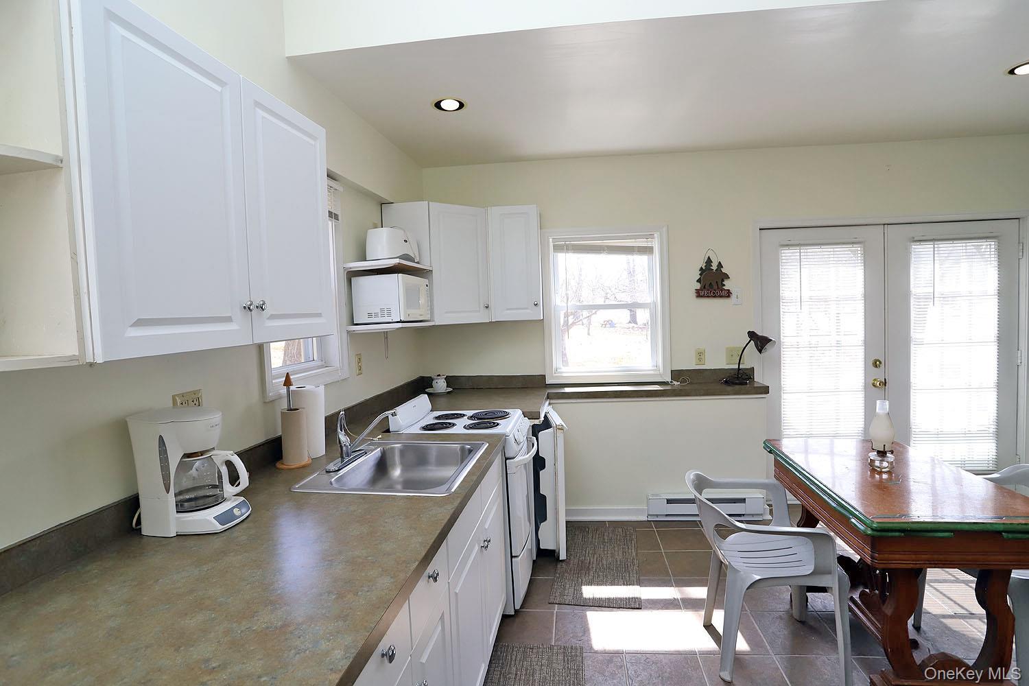 860 River Road Callicoon, NY 12723 - Photo 9 of 45 a kitchen with stainless steel appliances granite countertop a stove a sink dishwasher and cabinets with wooden floor