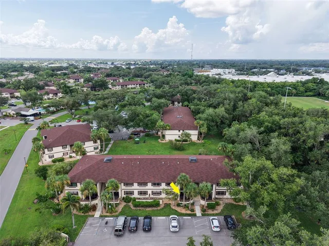 an aerial view of a house with backyard space and garden