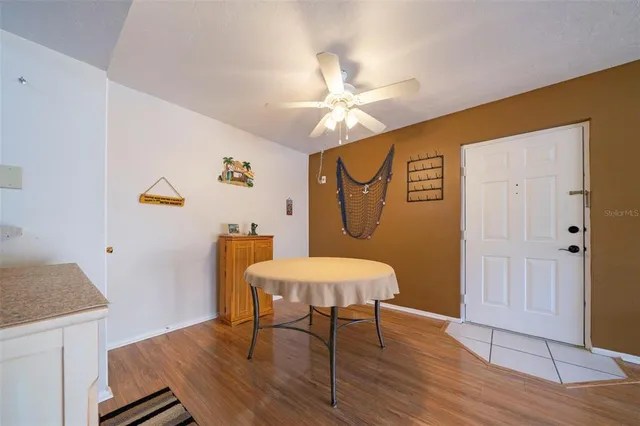 a view of a dining room with furniture and wooden floor