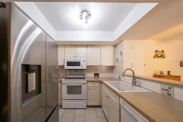 a kitchen with a sink cabinets and stainless steel appliances