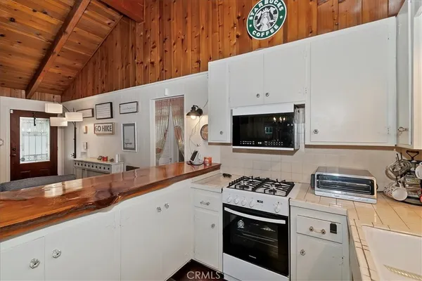 a kitchen with stainless steel appliances a stove a sink and a microwave